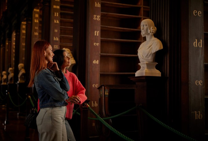 Two women admiring a female sculpture