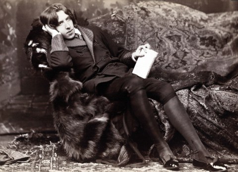 A black and white photo of a reclining Oscar Wilde
