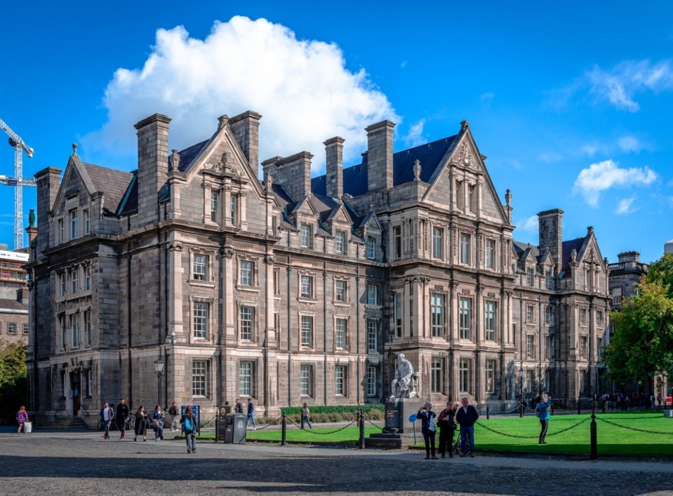 Photo of the Graduate Memorial Building on Trinity College Campus, with tourists admiring the beautiful architecture