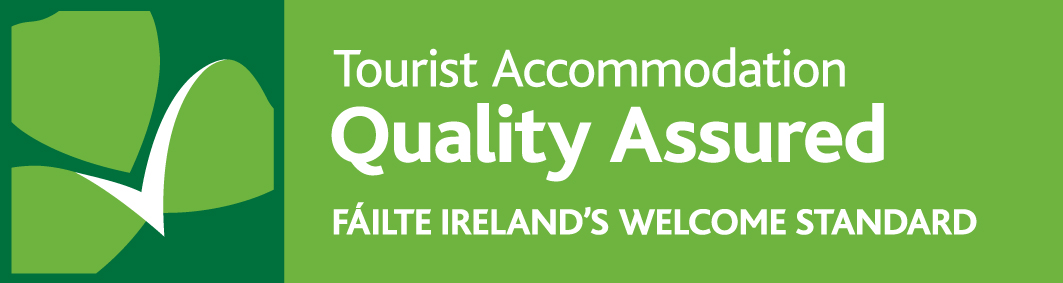 "Tourist Accommodation Quality Assured" Failte Ireland's Welcome Standard logo in green , dark green and white